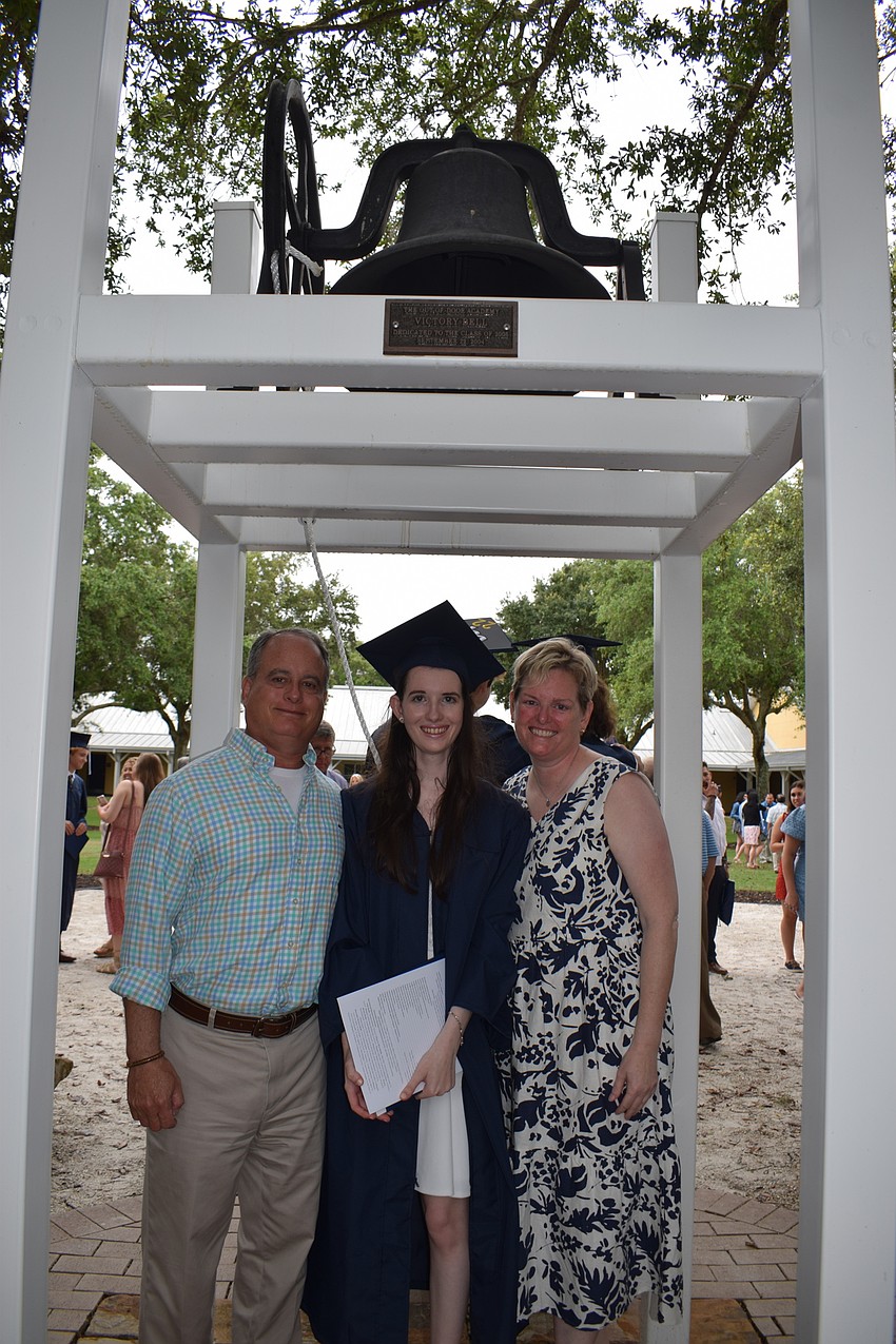 Marc Soss and his daughter Lindsay Soss and wife, Sarah Soss, ring the bell on campus. Lindsay Soss says graduating feels like freedom.