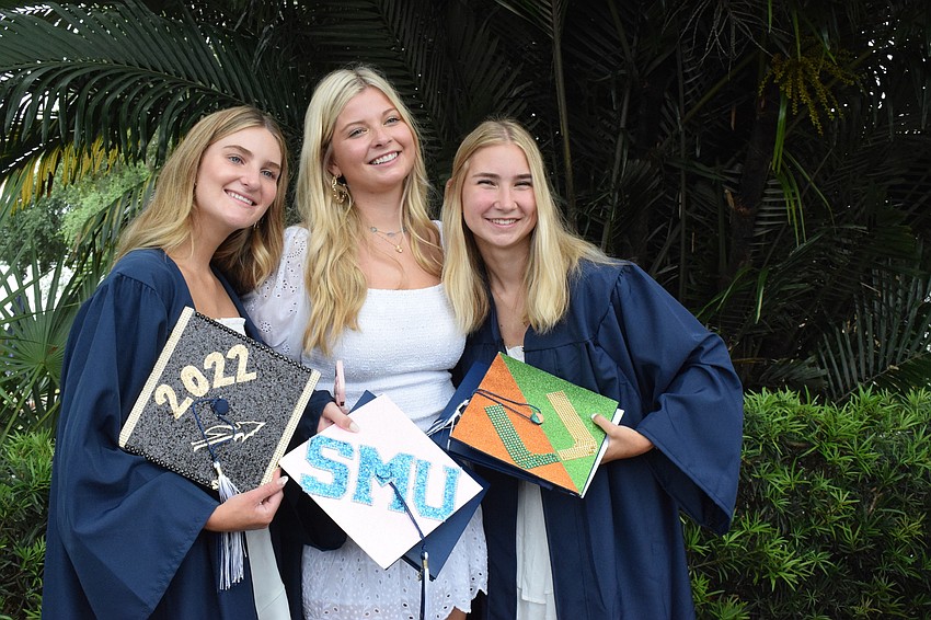Cate Paxton, Ella Lahners and Alexandra Morgan show off their decorated caps after the ceremony.