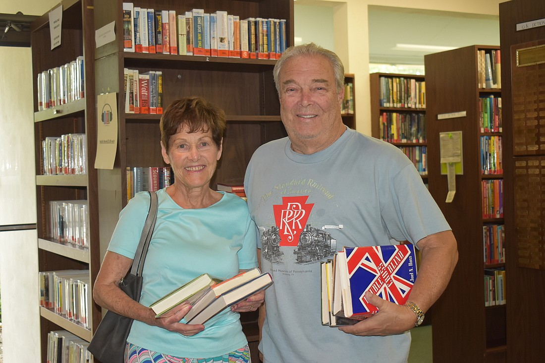Nancy and Jim Curtis checked out a half-dozen books to prepare for a rainy weekend.