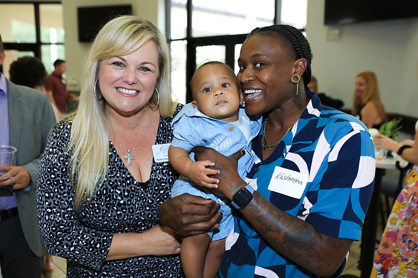 Mothers Helping Mothers director Cherie DeVries with Kireh and Kasheena Kimbrough