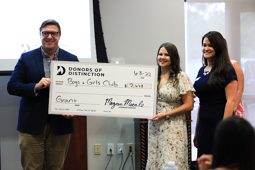 Representatives from various nonprofits accepted checks with Donors of Distinction members.