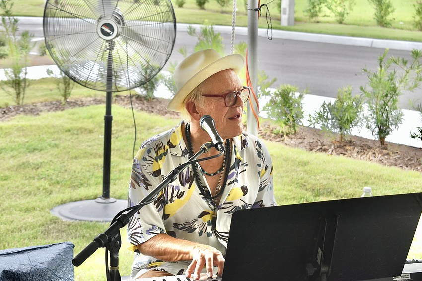 Robin Swenson plays keyboard for Kettle of Fish at the open house party.