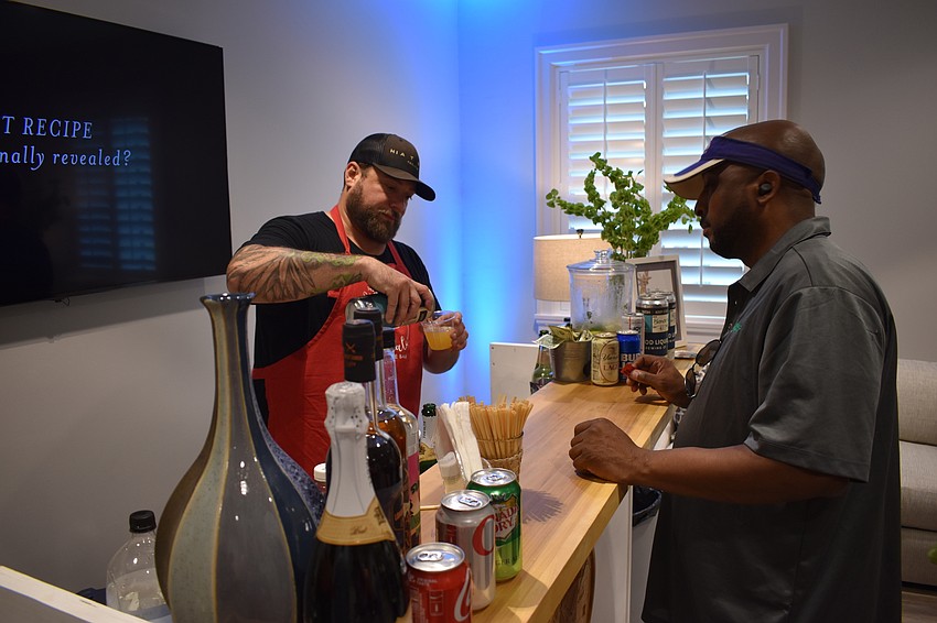 Good Liquid Brewing Company's Mike Scalzi pours a beverage for Lakewood Ranch's Robert Davis.