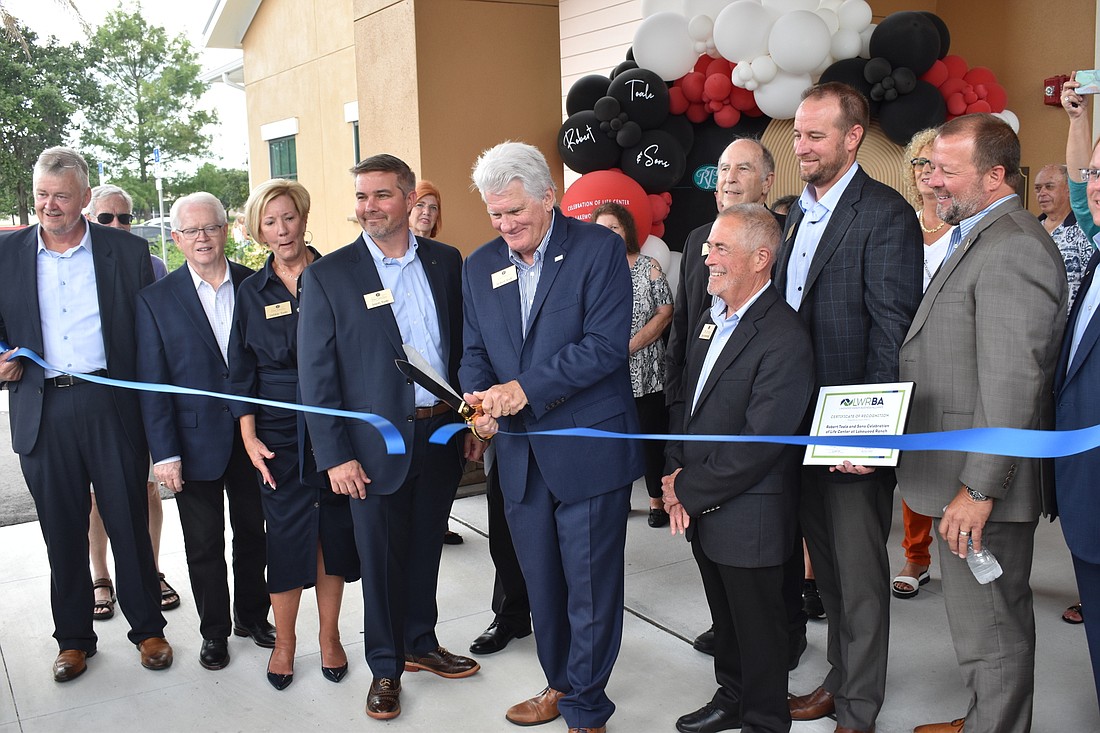 Your Observer | Photo - Robert Toale cuts the ribbon for the ...