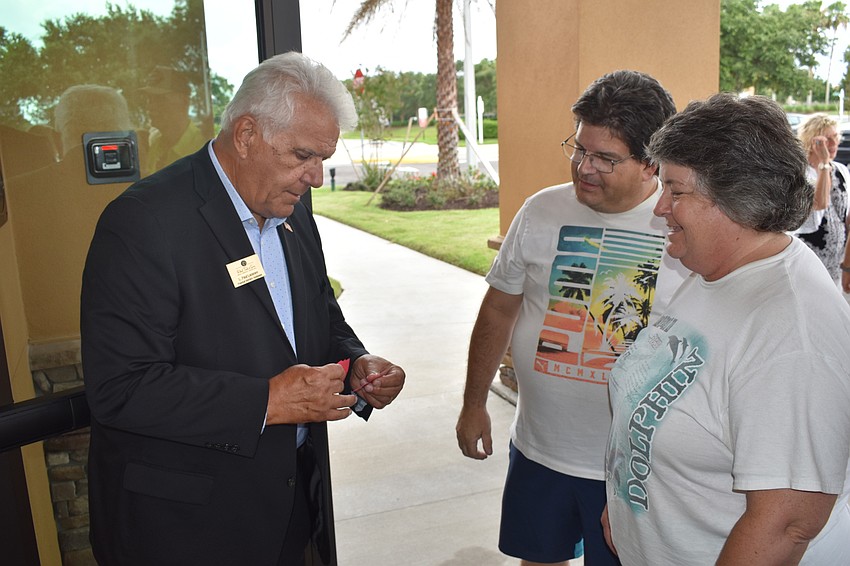 Funeral Service Assistant Paul Laramee visits with East County's Thomas and Dawn Murphy.
