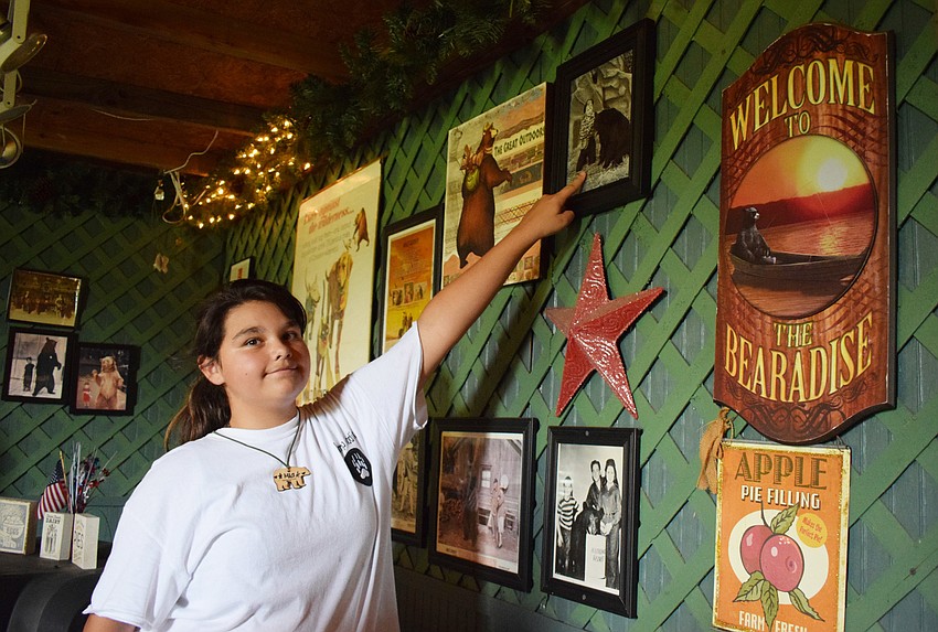 Mia Dyer, who is 10, shows a photo of Lucy, a bear at Bearadise Ranch, performing with Lucille Ball. Dyer learned facts about every bear at Bearadise Ranch.