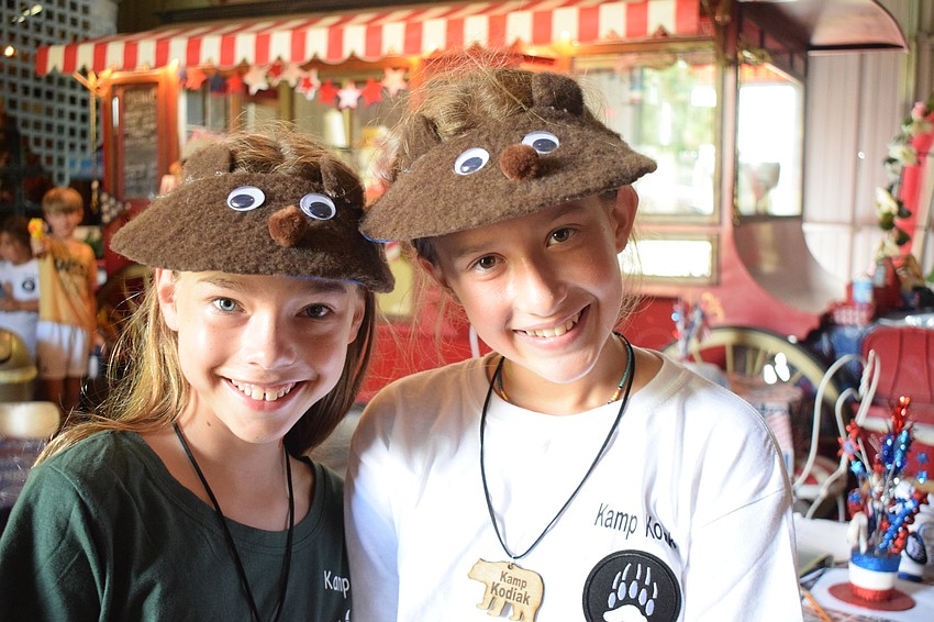 Sidney Lamarre and Leighton Cracchiola, who are both 11 years old, show off the bear visors they made. Lamarre and Cracchiola both say their favorite animal is a bear, which is why they wanted to participate in Kamp Kodiak.
