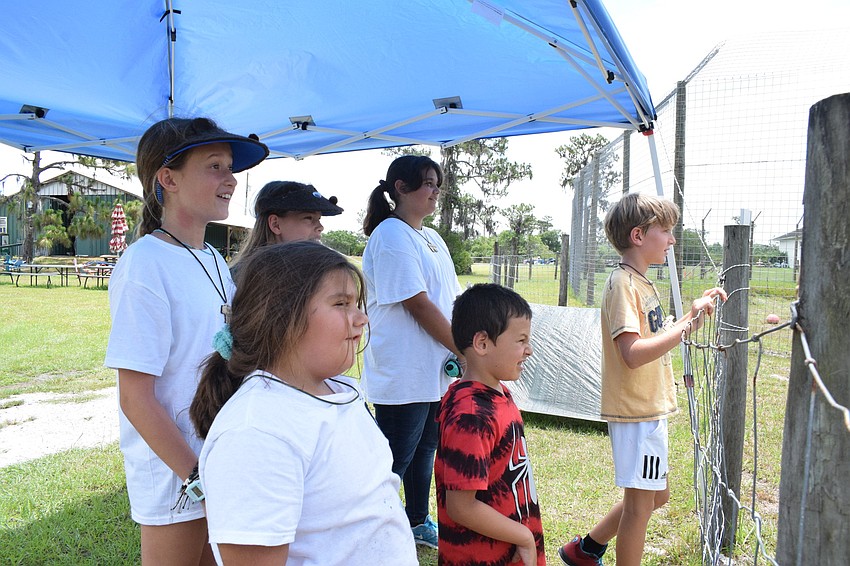 Campers Emmy Dyer, Leighton Cracchiola, Sidney Lamarre, Bjorn Welde-Thomas, Mia Dyer and Mateo Murariu watch in amazement as Bruno, a bear, shows off some of his tricks.