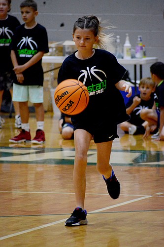 Adriana Buchanan, 9, said she had never played basketball before, but enjoyed learning how to dribble.