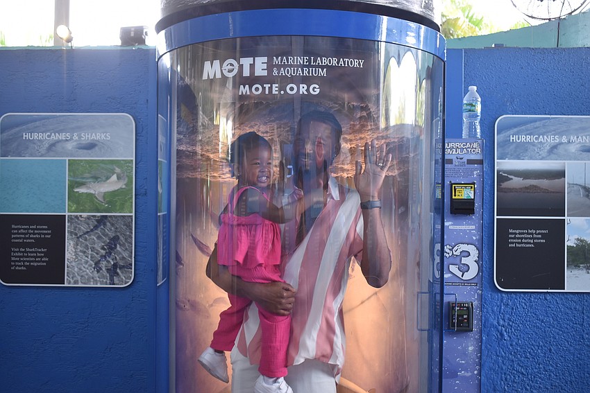 Madisyn and Montrel Cox test the hurricane simulator.