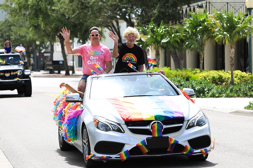 Parade riders wave to the crowd.