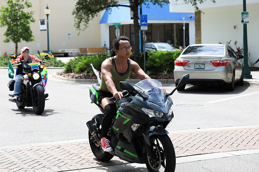 Motorcycle riders go through Main Street to cheers.
