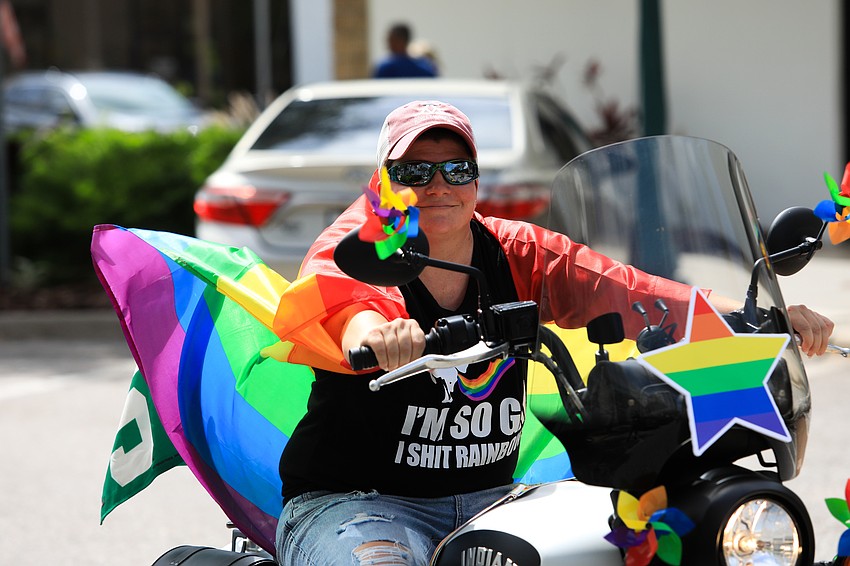 Motorcycle riders go through Main Street to cheers.