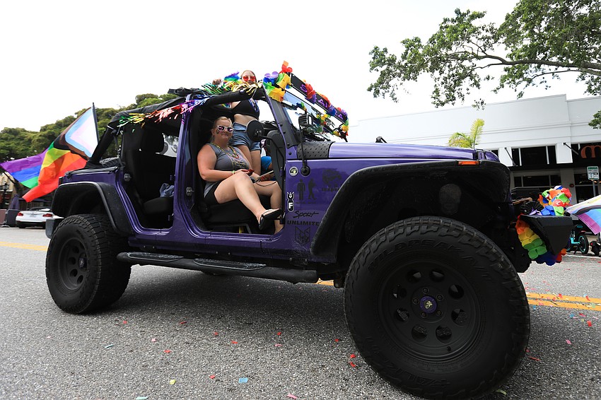 Parade riders wave to the crowd.