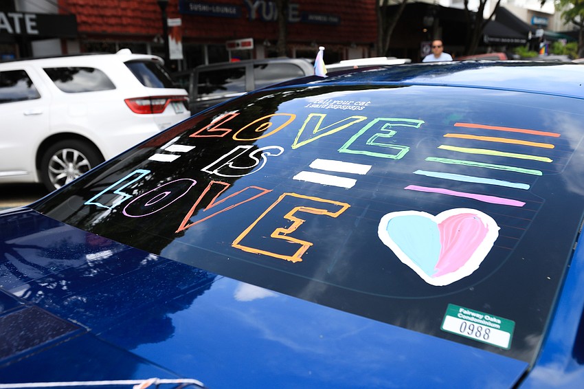 Vehicles cruise through Main Street.