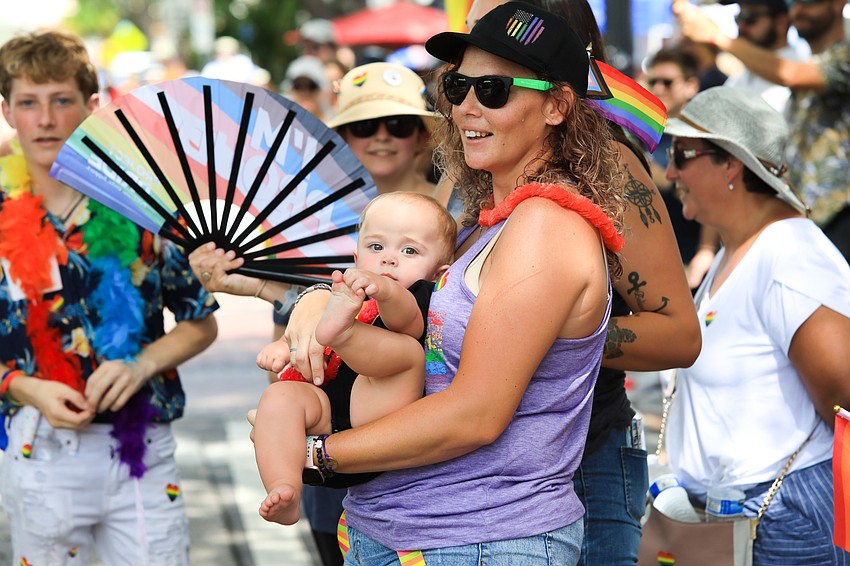 MacKinzie and Ocean Deets cheer on the vehicles.