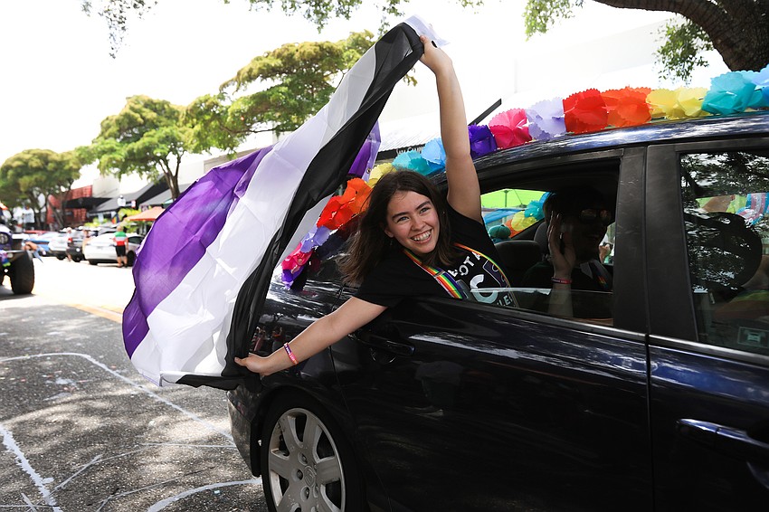 Parade riders wave to the crowd.