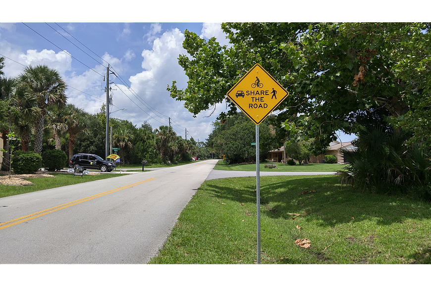 A "share the road" sign on Cimmaron Drive. File photo