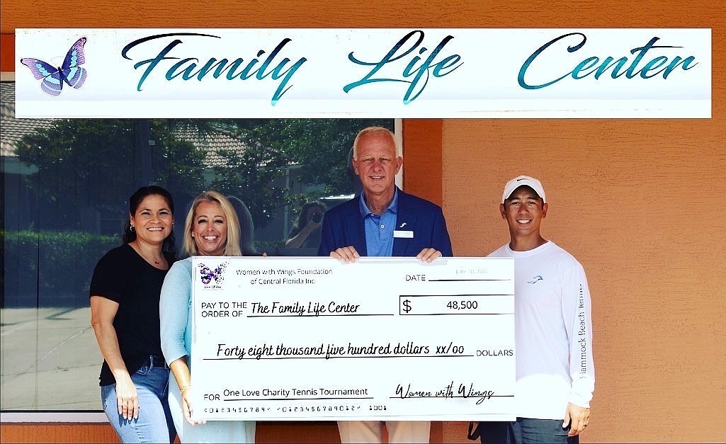 One Love's check presentation to the Family Life Center: Trish Giancone of the Family Life Center, Kerry Cooke, Hammock Beach General Manager Brad Hauer and Director of Tennis Gene Paul Lescano. Courtesy photo