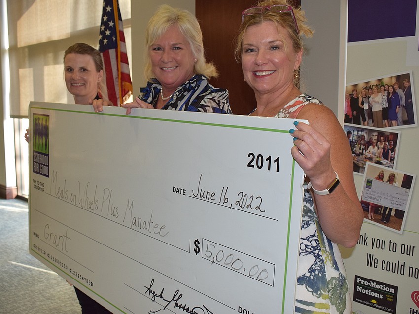 Meals on Wheels Plus-Manatee's Amy Towery and Maribeth Phillips pick up a cool $5,000 from Sisterhood for Good's Lorri Kidder, the grants committee chair.