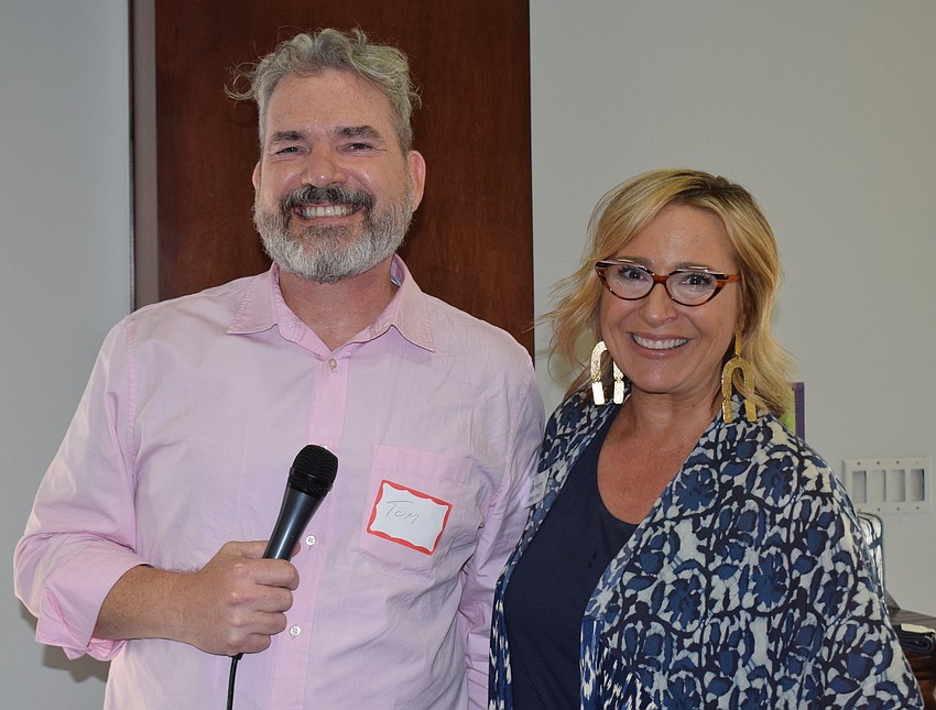 SPARCC's Tom Foley is all smiles as he collects a $2,500 check from Sisterhood for Good member Allison Imre, the CEO of Grapevine Communications. SPARCC stands for Safe Place and Rape Crisis Center.