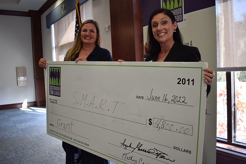 SMART's Rebecca Blitz accepts a $4,800 grant from Sisterhood for Good's Brenda Kleiber.