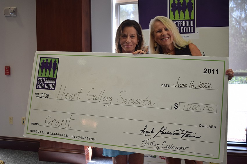 Heart Gallery CEO Allison Juceam celebrates the grant with Sisterhood for Good's Becca Towery.