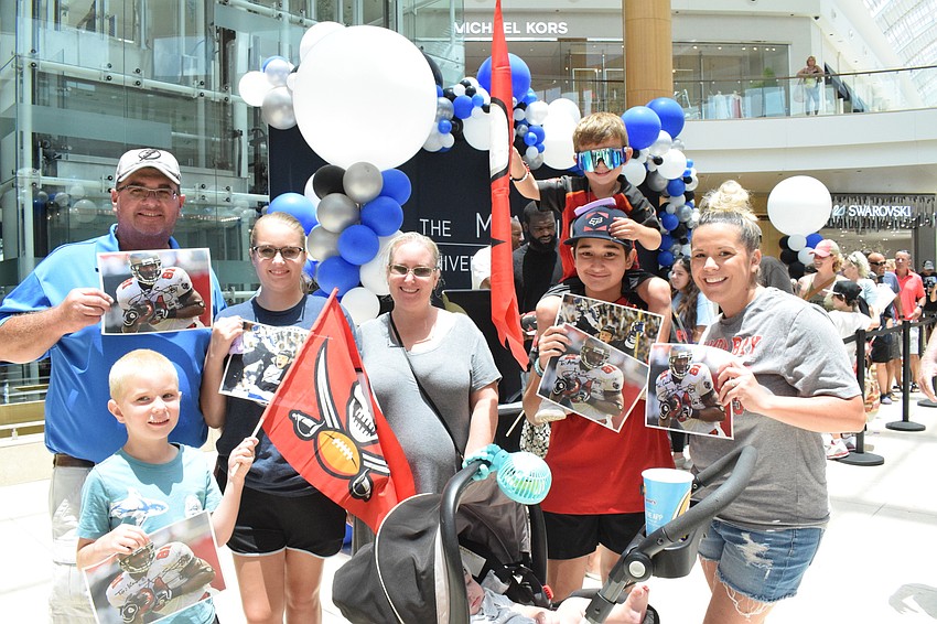 Lakewood Ranch's Jason Wilson gets signed photographs with his family, 6-year-old Kaden, 14-year-old Celeste and wife, Melanie, and his neighbors 4-year-old Camden Hadra, 12-year-old Amelia Someson and Krystina Hadra.