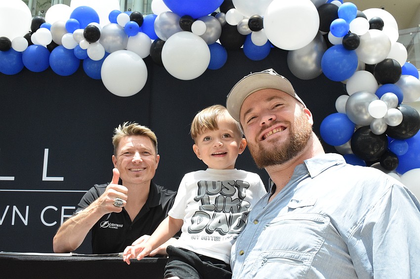 Ruslan Fedotenko, who played for the Lightning, signs an autograph for Sarasota 2-year-old Lucas Lindbloom and his dad, Thomas Lindbloom.