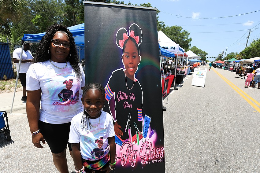 Kenneyetta Williams Jackson and Rylah Jackson sells gloss at the Glittery Gloss tent.