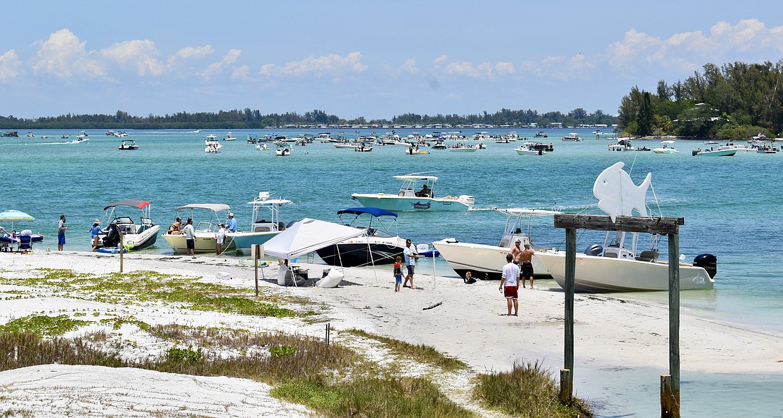 The beach on Greer Island is a popular boating destination.