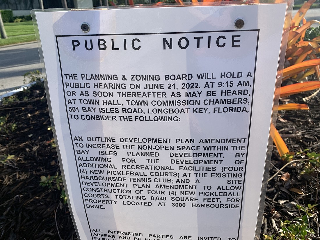 A notice of the Tuesday public hearing was posted at the north gate to Bay Isles.