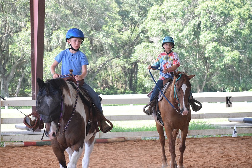Cayden Rowell, who is 10, and his 9-year-old brother Lucius Rowell participate in their second summer camp at Sarasota Manatee Association for Riding Therapy.