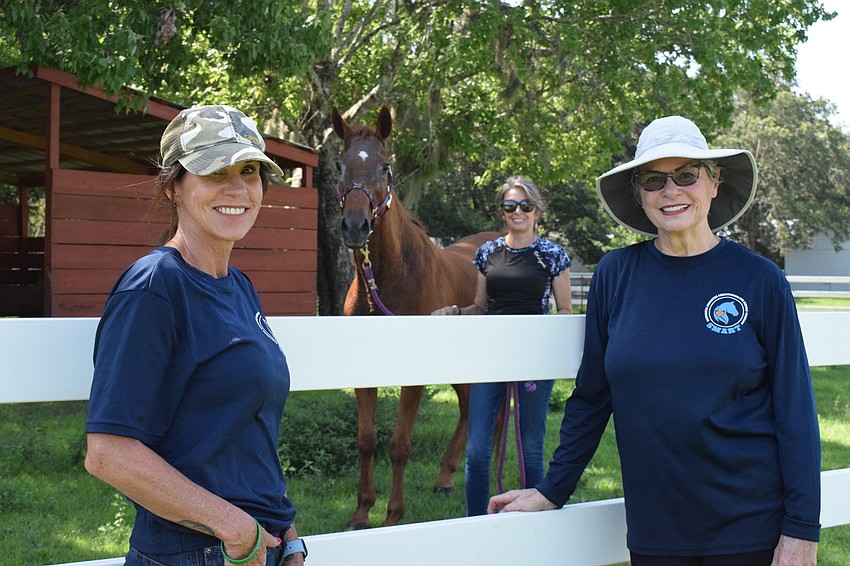 Instructors Ilee Finocchiaro, Lisa Morningstar and Terrie Arnold introduce Ollie, a new horse to Sarasota Manatee Association for Riding Therapy.