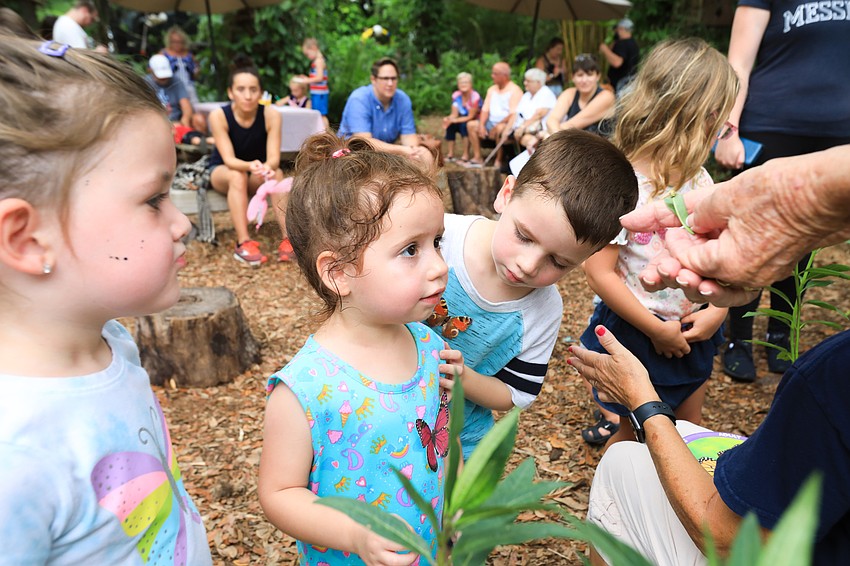 Beatriz and Miguel Garcia check out the small caterpillar.