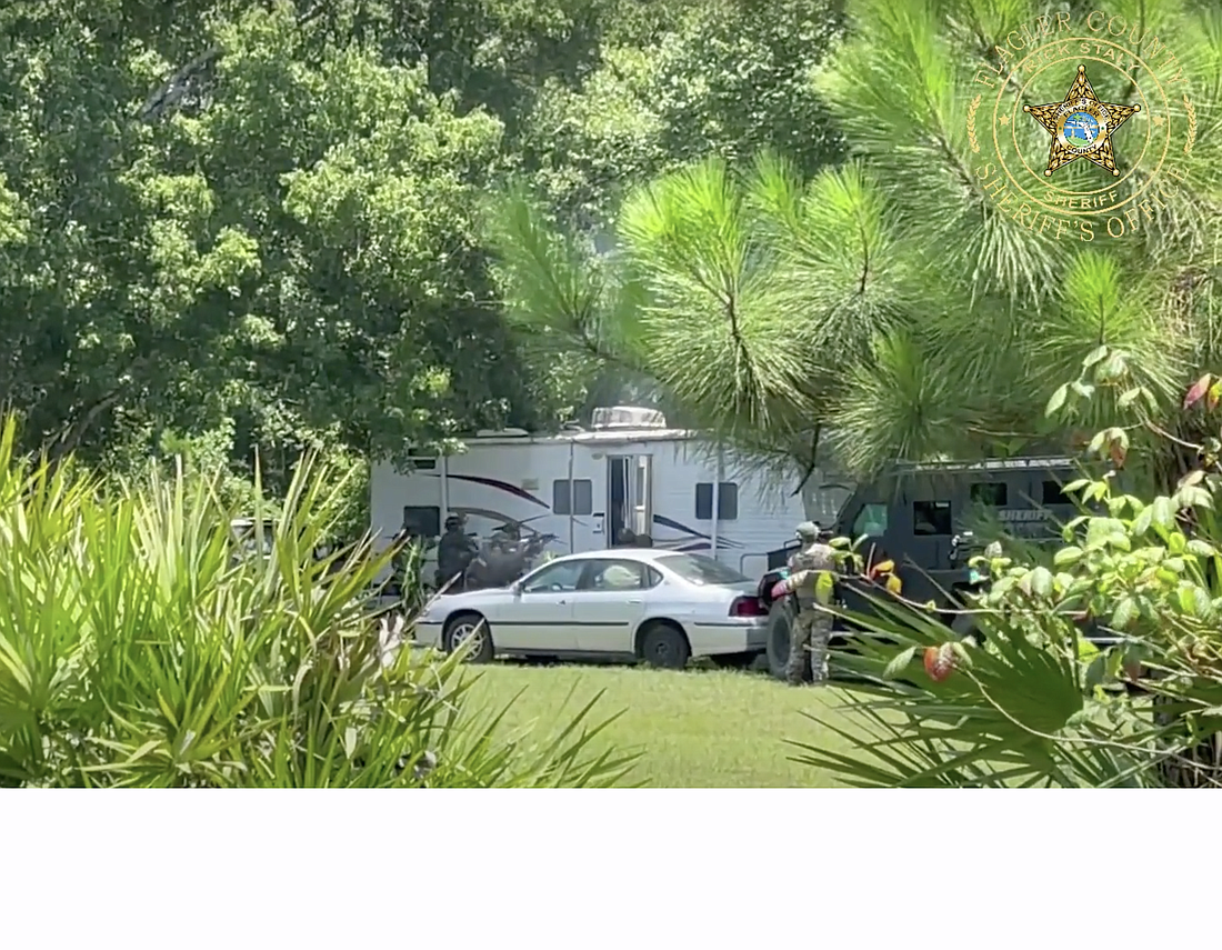 Deputies order people out of the suspect's trailer. Photo courtesy of the FCSO