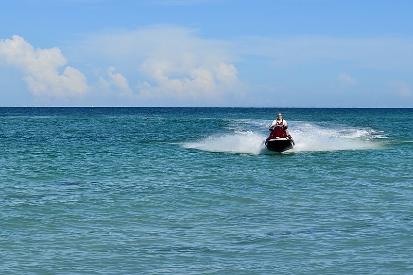 Alan Jenkins drives the jet ski during an annual water rescue training.