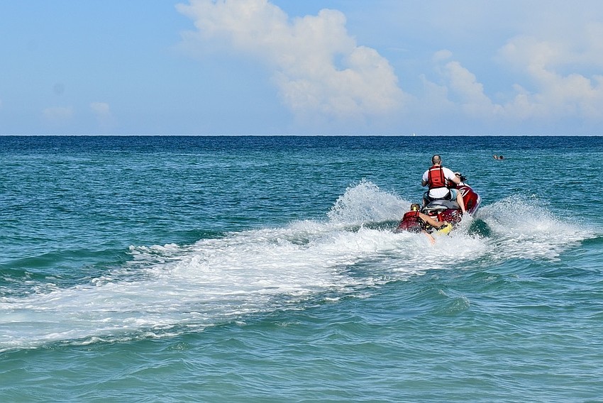 Ron Koper and Alan Jenkins perform water rescue training in the Gulf of Mexico.