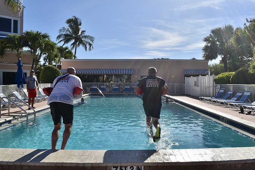 Roy Routh intstructs Jason Berzowski and Jeff Bullock on water rescue techniques.