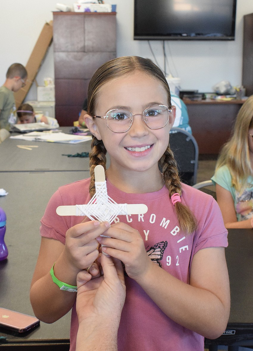 Reese Gilman shows off her craft in which she used yarn to make 