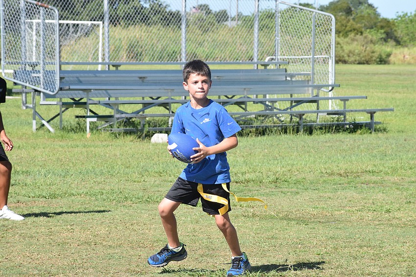 Jake Blazer plays quarterback  and looks for an open receiver during the YMCA's camp.