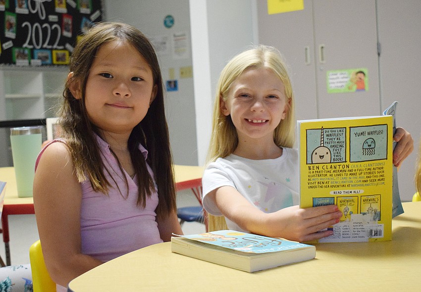 Eleanor Mattei listens intently as Lily Colcu reads to her in a whisper. During reading time, all the campers read either by themselves or together quietly to help retain their reading skills.