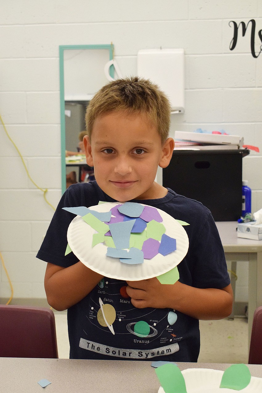 Ethan Boudreau is proud to show off his finished turtle. 