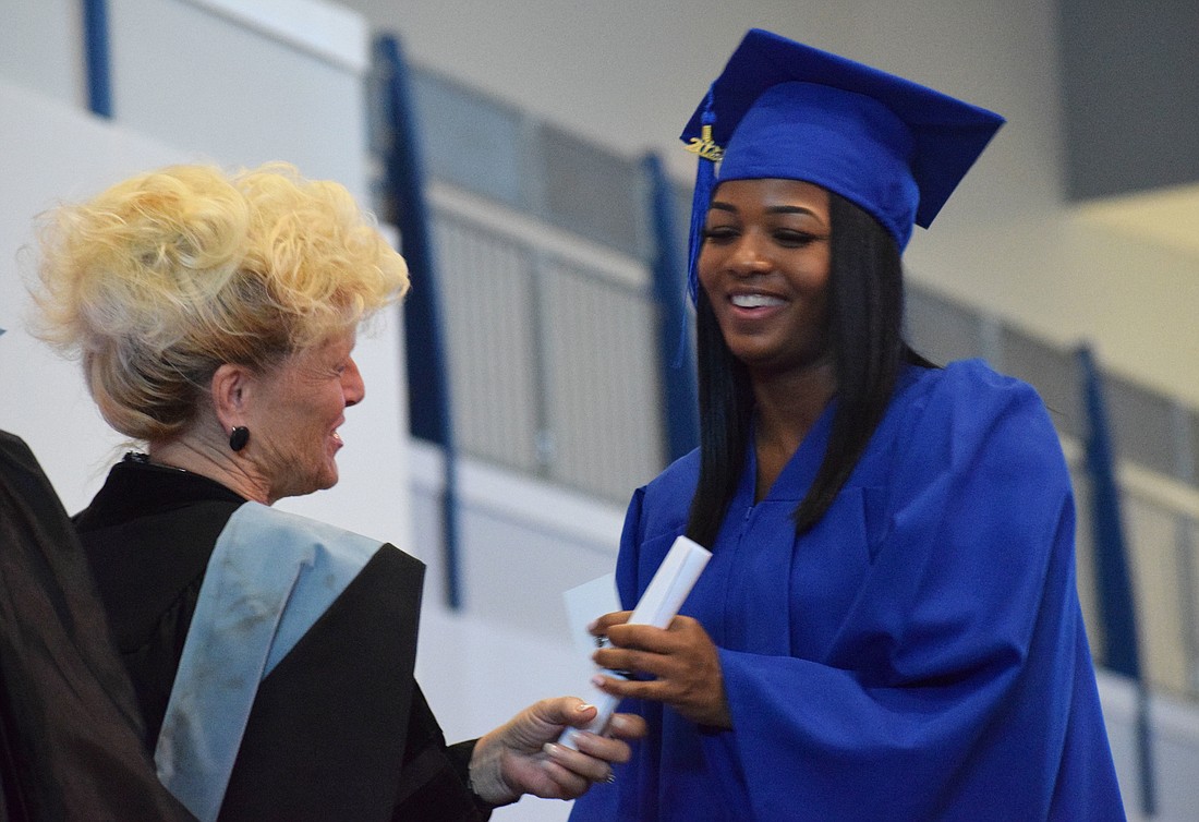 Valerie Viands, the director of Manatee Technical College, hands Sarasota&#39;s Jasmine Redding her diploma. Redding has a job with Nurse Core and plans to work part time for HCA Florida Blake Hospital or First Physicians Group.