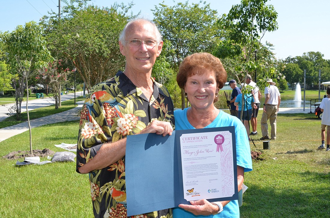 Brenda Knowles, right, president of the Bloom & Grow Garden Society, presented on behalf of the club a certificate of appreciation to Winter Garden Mayor John Rees.
