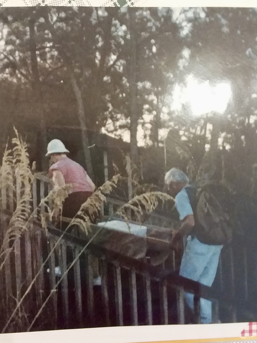 Clayton Orville and an unidentified member of the LBKTW carrying turtle eggs from the beach in a styrofoam cooler during the '80s.