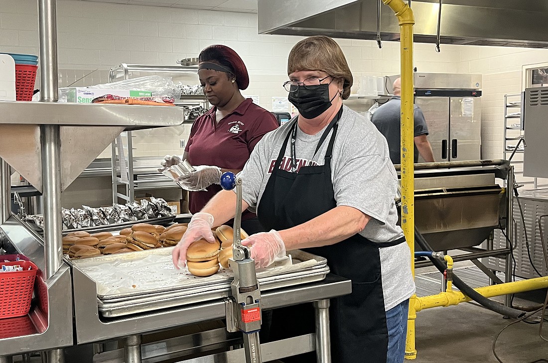 Toquya Jones and Margaret Laughlin, food service workers at Braden River High, prepare lunch for students. (File photo)