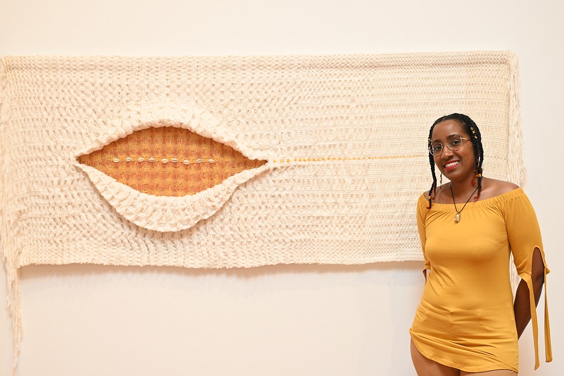 Katrina Coombs stands with her piece "As It Breathes, Life is Taken." (Photo: Spencer Fordin)