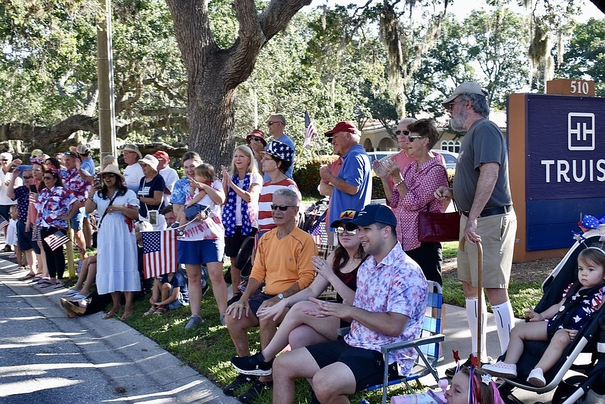 The crowd lines Bay Isles Road.