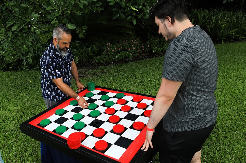 Kyle and Isaiah Sledge play checkers.